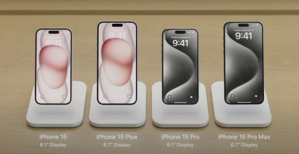 iPhone 15 2025 models displayed in-store with Dynamic Island and minimal bezels in multiple finishes