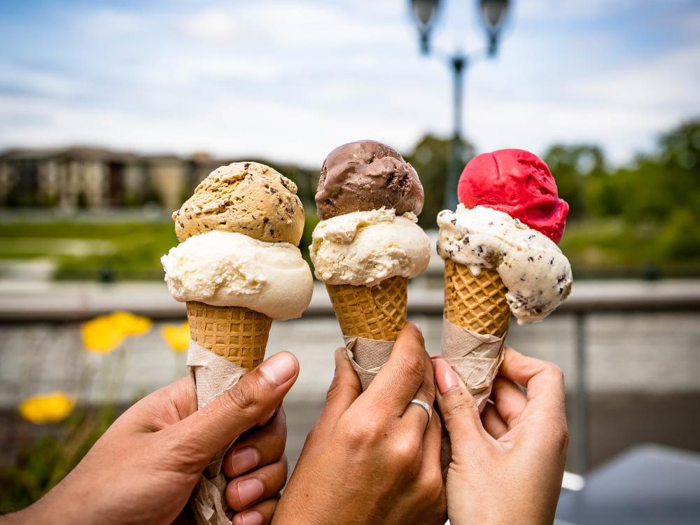 Colorful ice cream scoops in waffle cones on a summer day