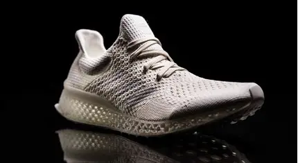 Close-up of Adidas laced 3D-printed 4DFWD shoes featuring futuristic lattice midsoles and breathable upper.