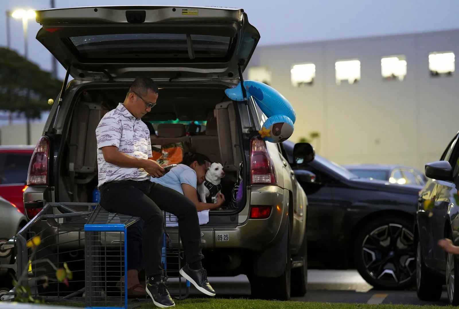 “People sitting at the back of a car during evacuation after Russia earthquake-triggered tsunami alerts in Hawaii.”