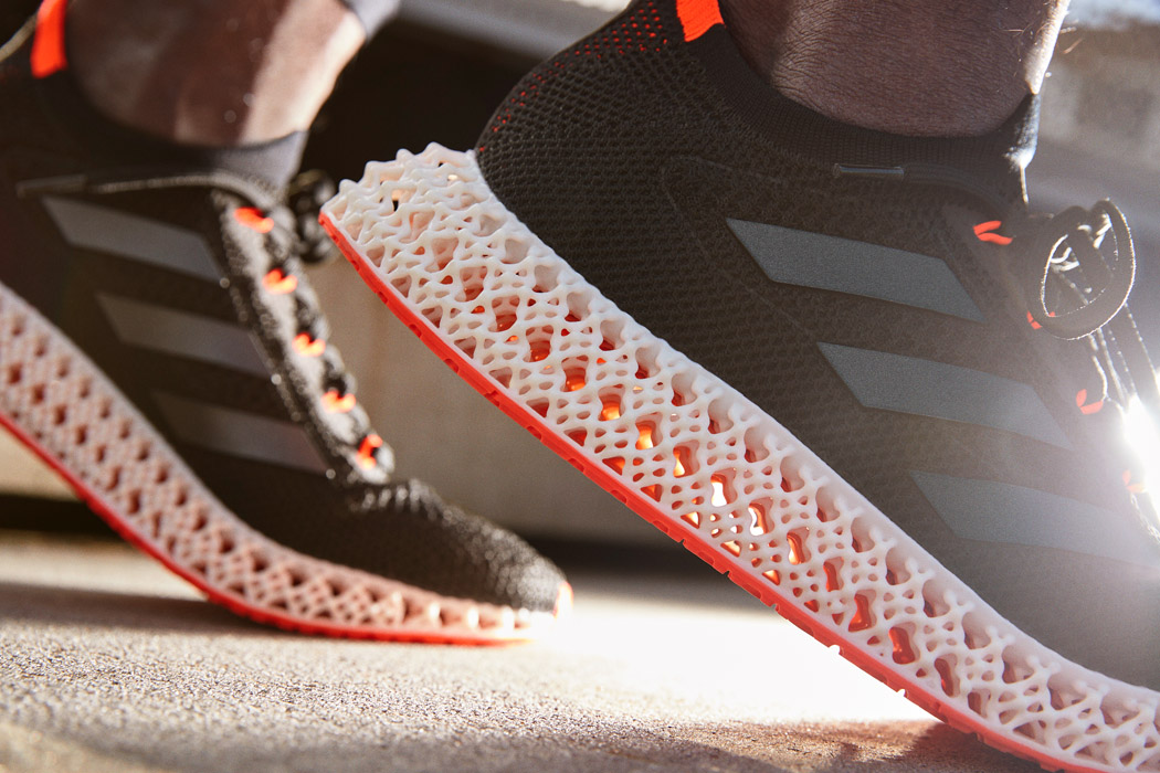Adidas 4DFWD sneakers with classic laces and 3D-printed lattice midsole in a modern design.