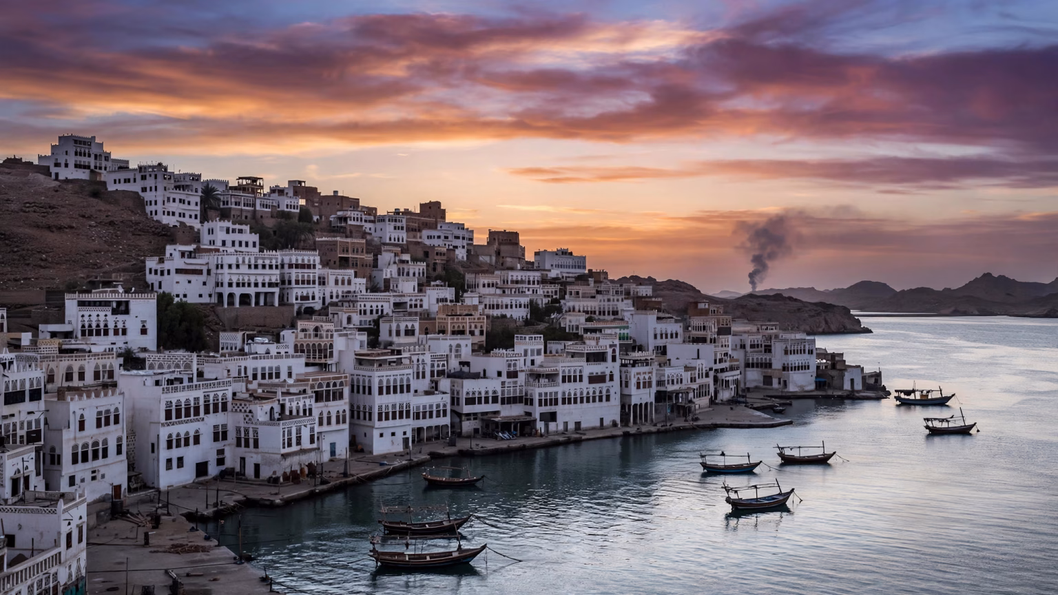 Smoke rising over a city skyline after a missile strike in the Middle East