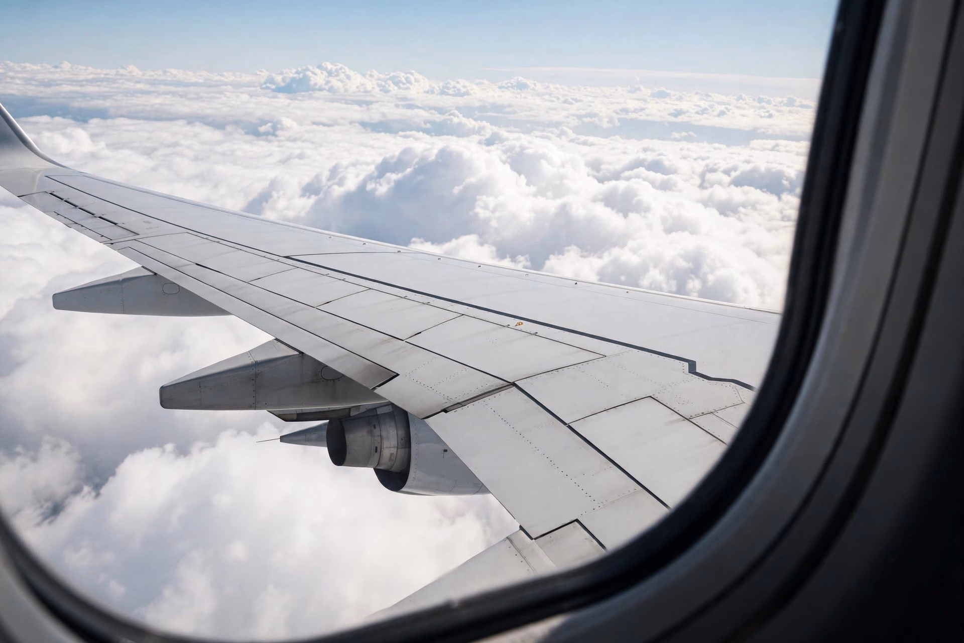 Airplane wing over the clouds during a domestic flight