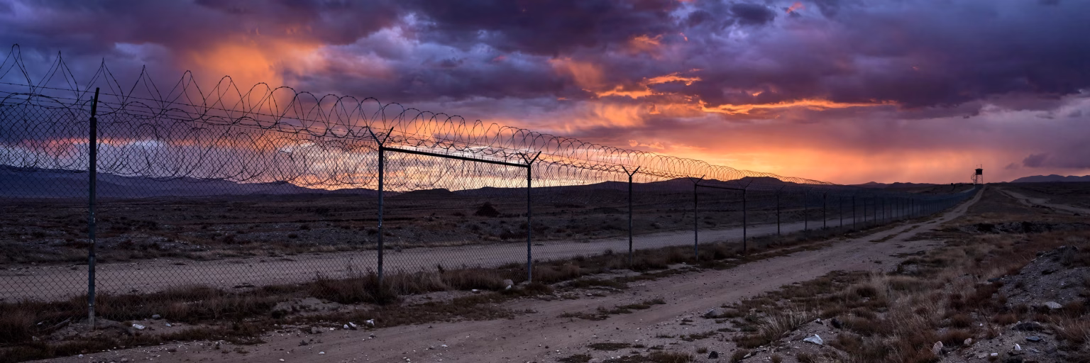 India-Pakistan Border Row: Envoys Summoned After Two Shot Dead in Punjab Firing Border security fence with barbed wire at dusk along an international border