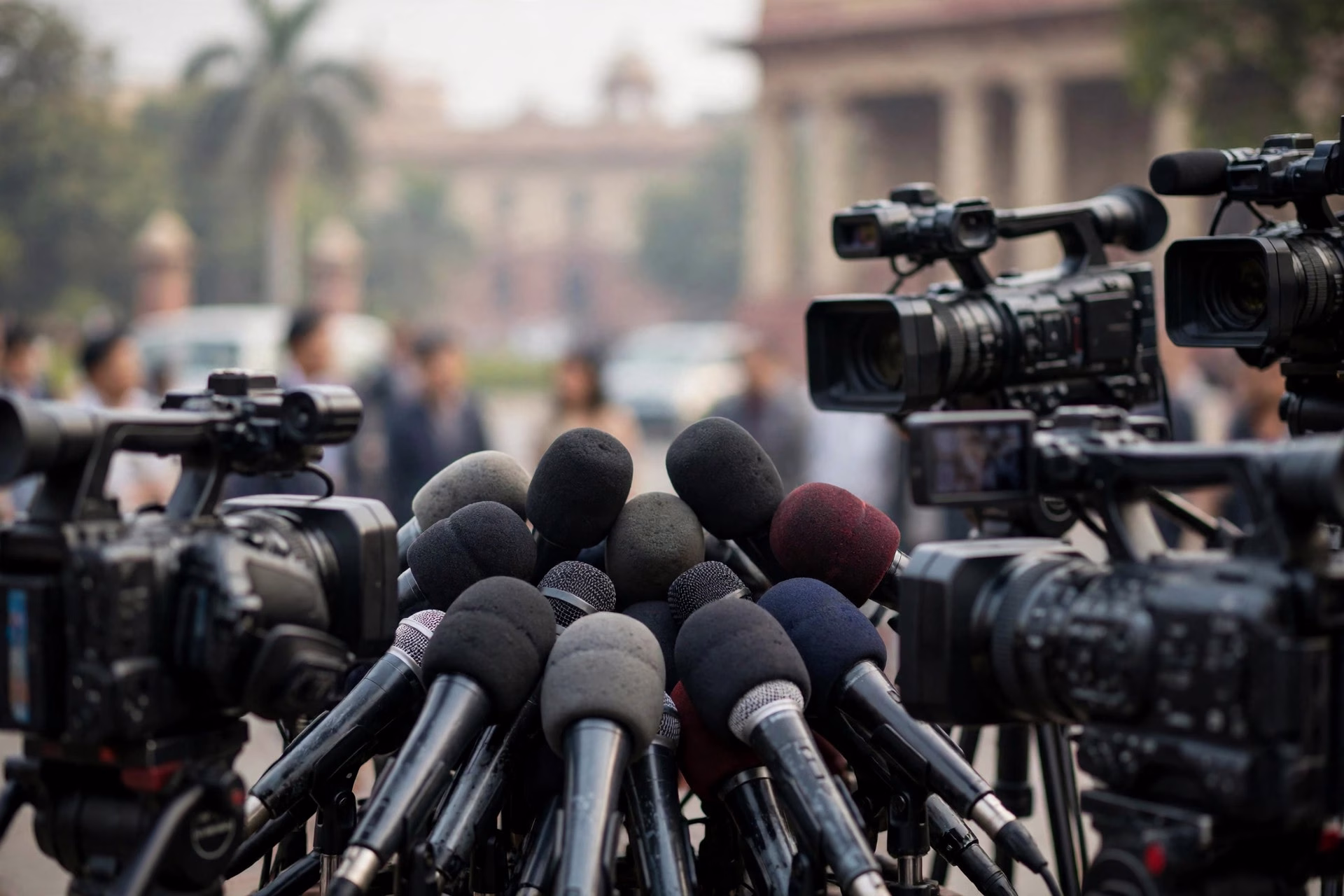Microphones and media cameras at a political press conference in Delhi